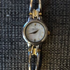 Bulova Silver and Gold Dress Watch with Elegant Design and Thin Bracelet
